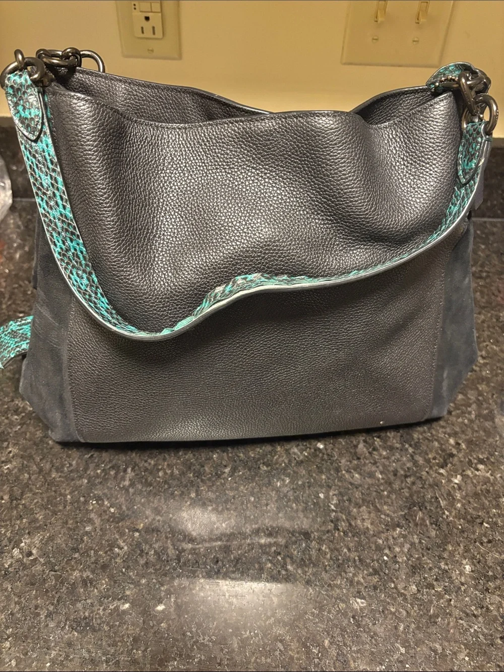 Black Leather Coach Dalton 31 with teal green snake print trim